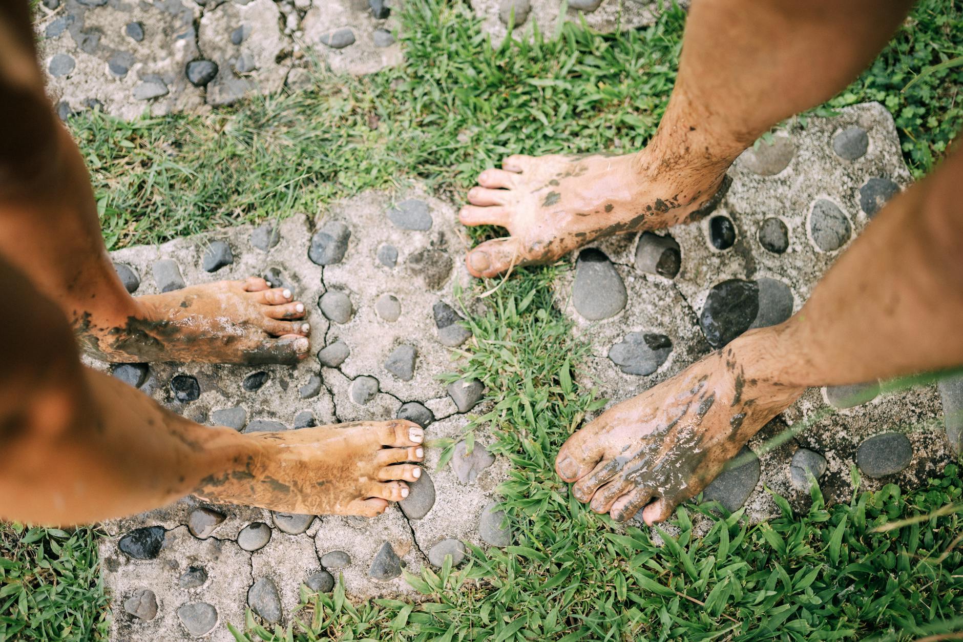 Barefoot Balance and Proprioception Training on Natural Surfaces Two people standing barefoot on a natural stone path outdoors, demonstrating natural proprioceptive training
