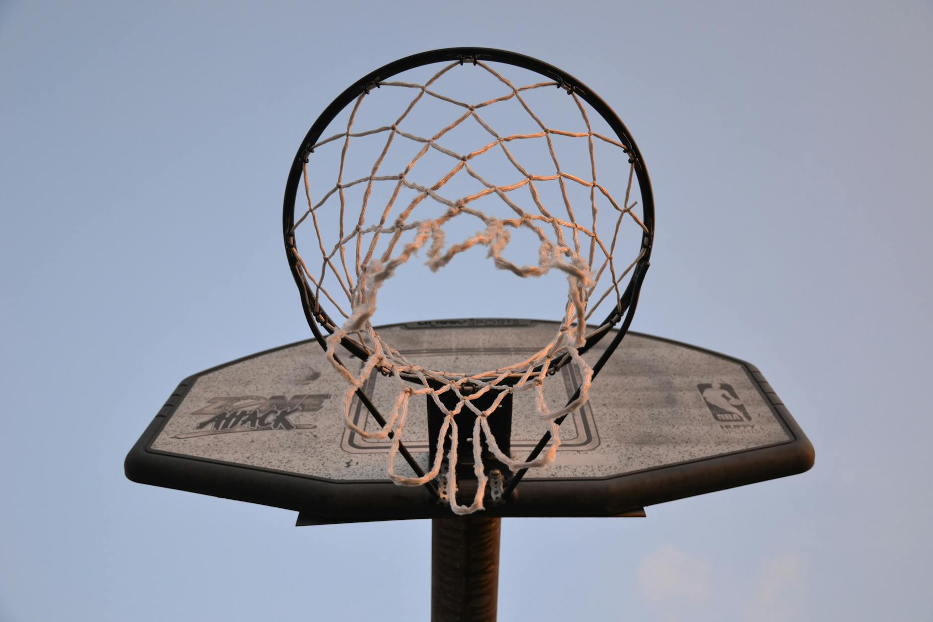 Basketball Court and Hoop Close-up view of basketball hoop and net against sky