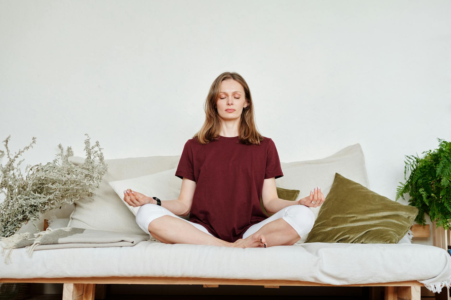 Woman meditating indoors for stress reduction and overall wellness