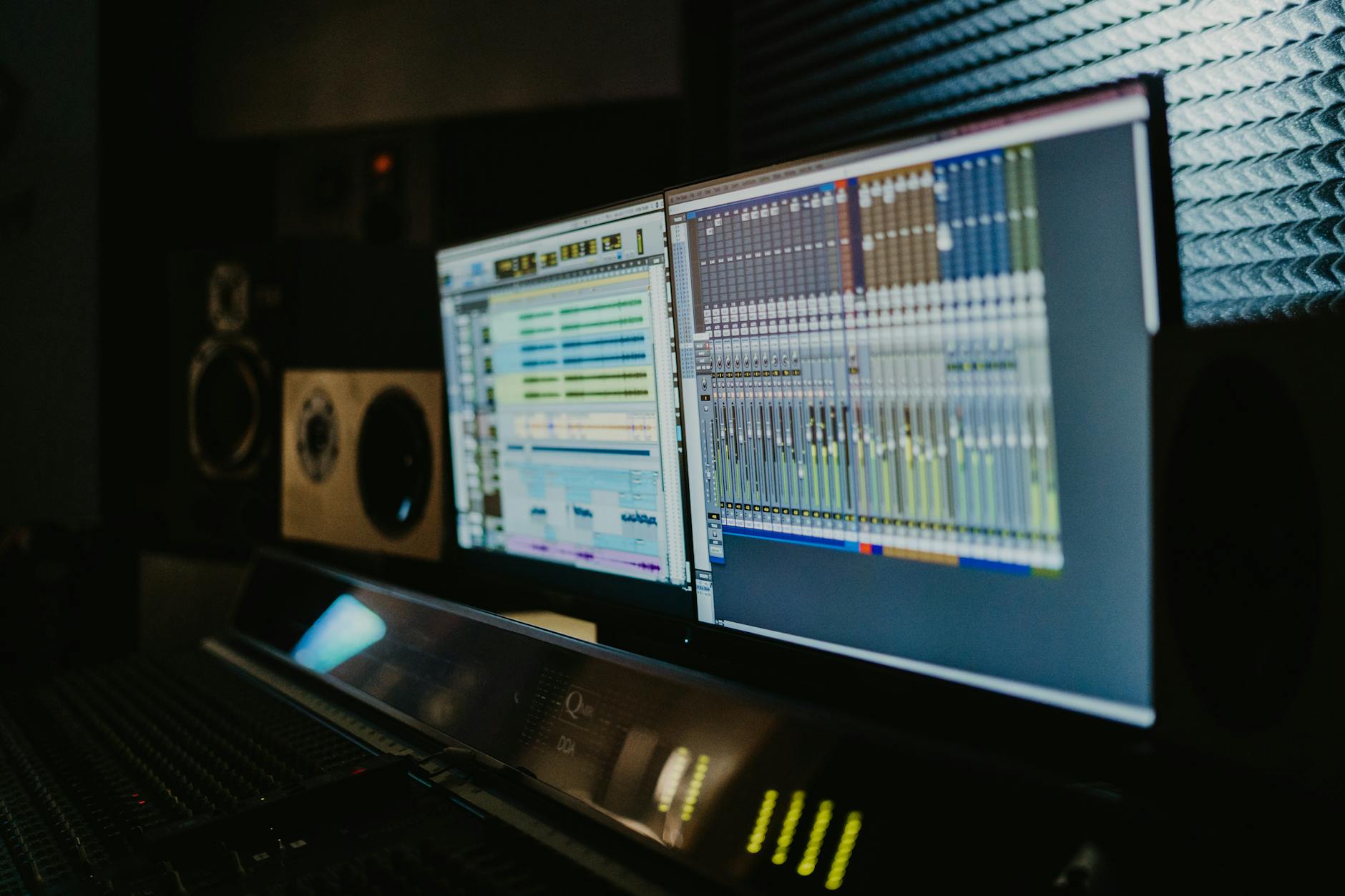 Professional audio studio with dual monitors and EQ software showing how equalizer settings shape sound