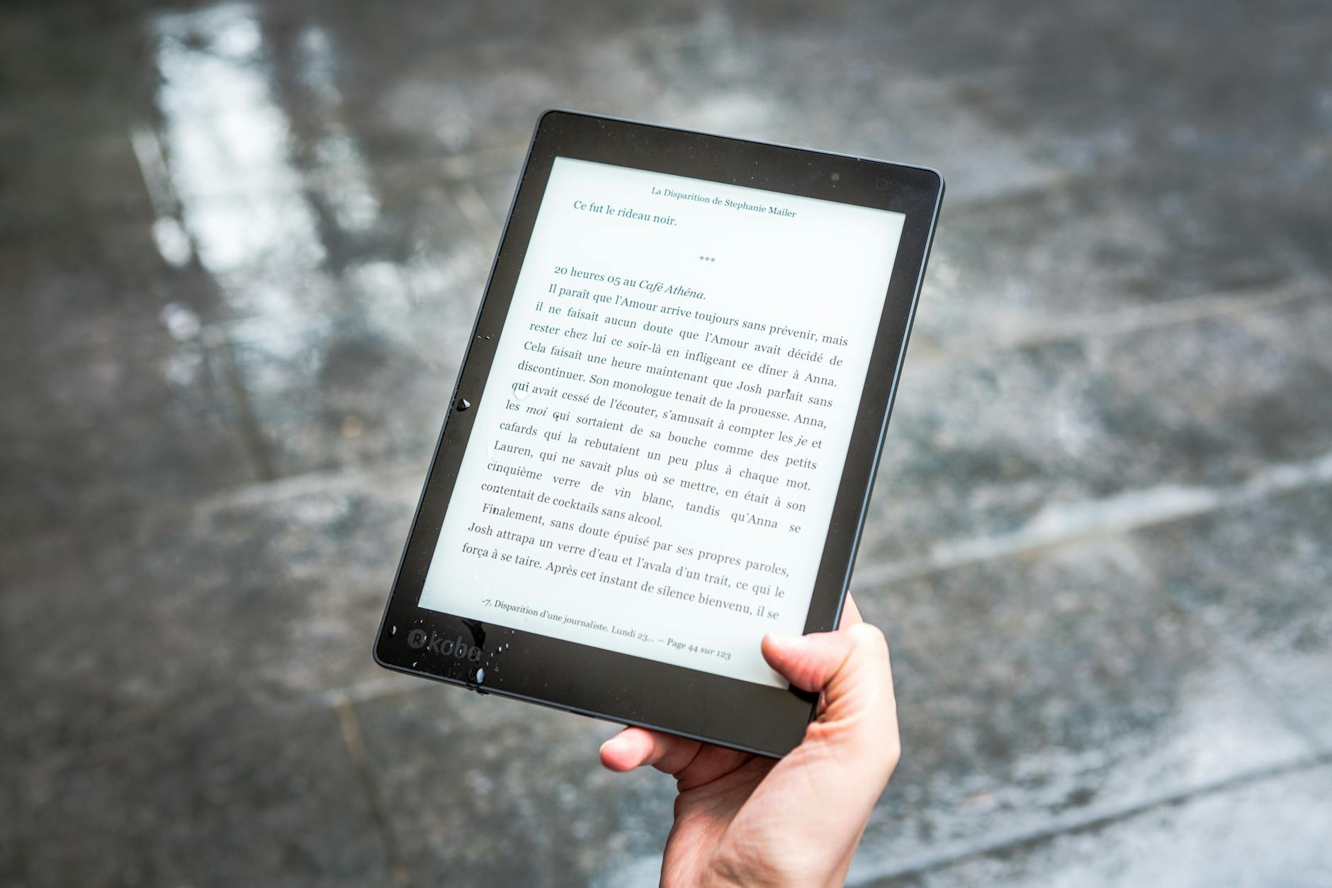 IP Ratings and Real-World Water Exposure for Electronic Devices Person holding an e-reader device in wet conditions — showing real-world need for IP-rated electronics