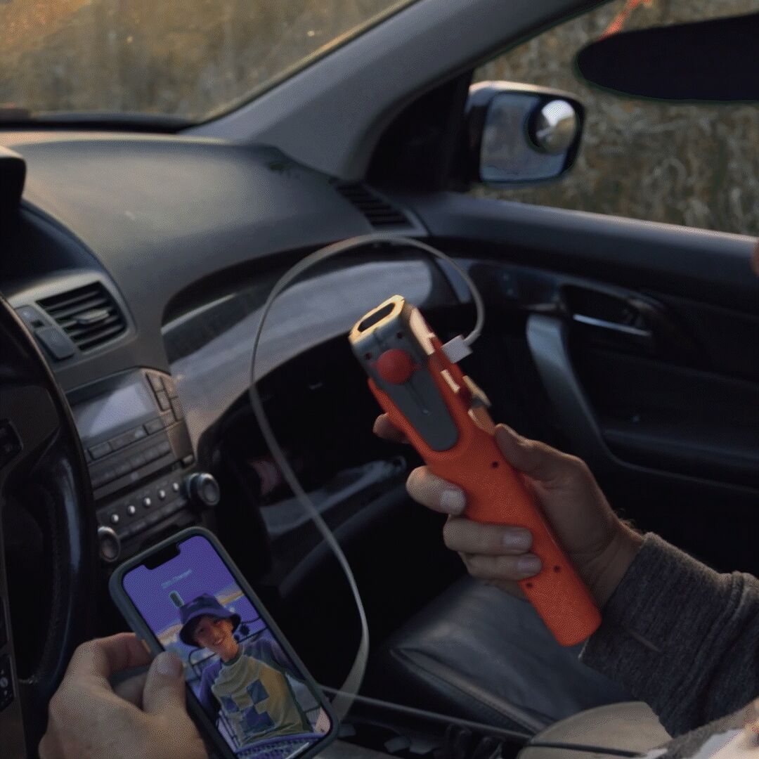Person using Kelvin 8 LED flashlight to illuminate under a car hood at night