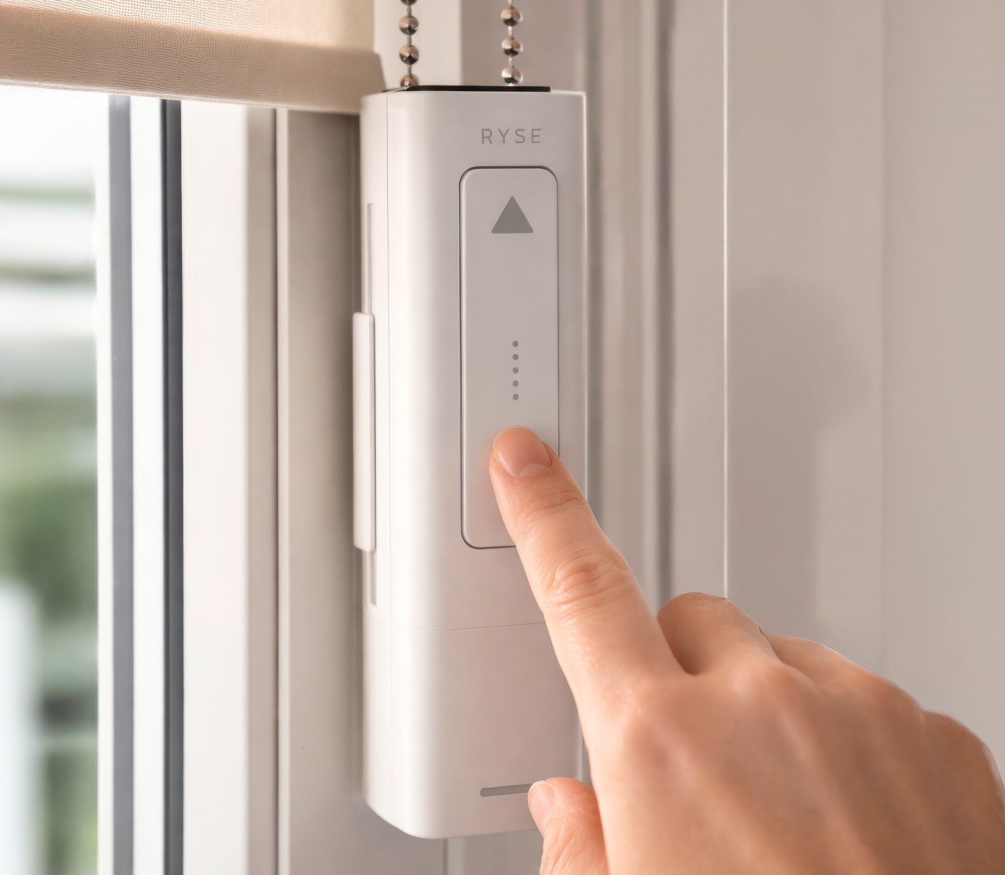 RYSE SmartShade installed in a modern living room setting showing automated shade control