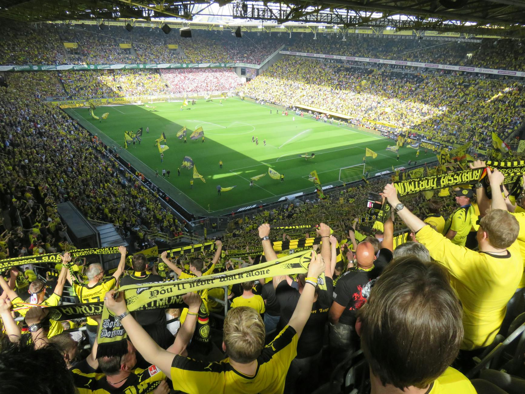 Stadium crowd full of passionate fans creating an electric game day atmosphere