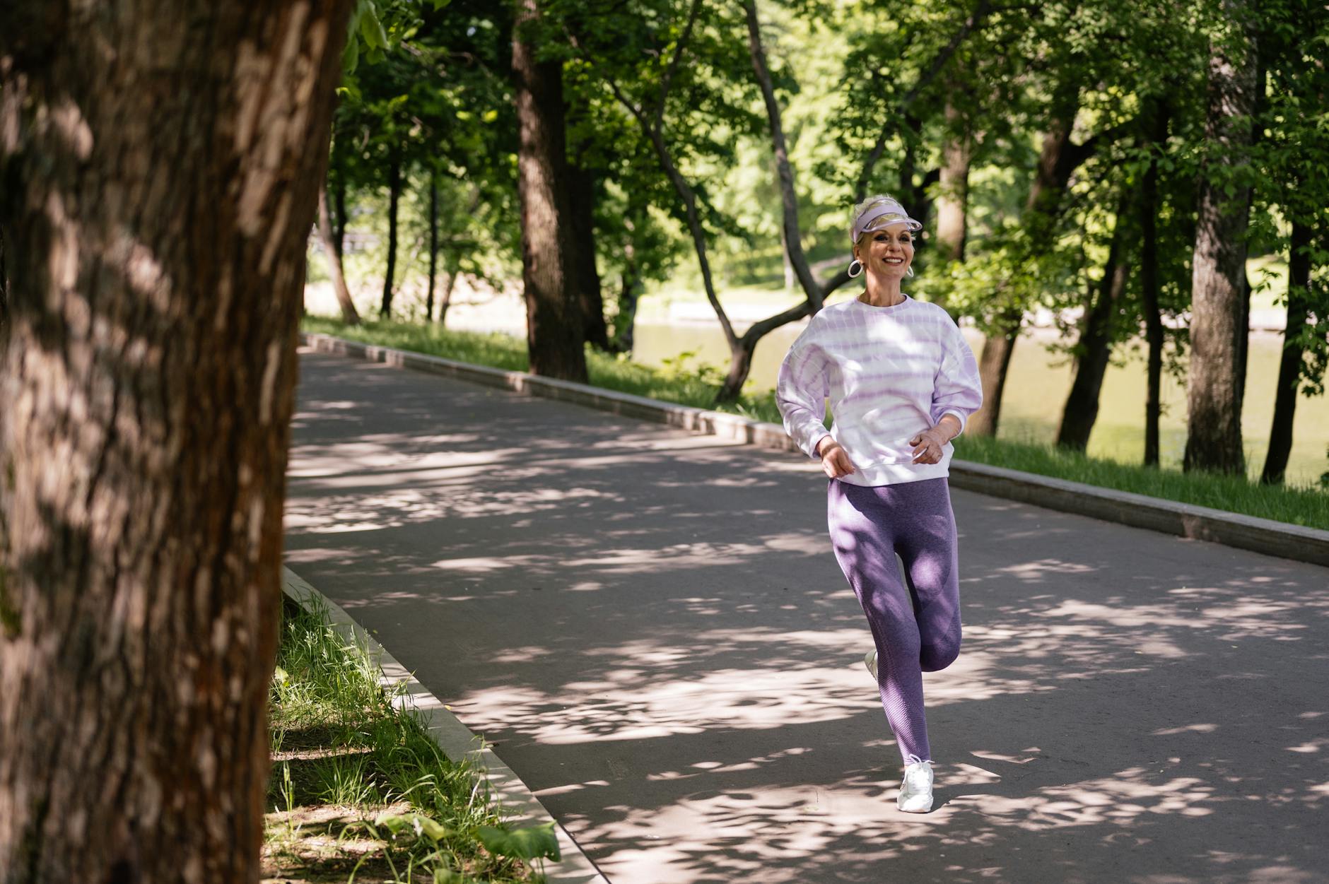 Elderly woman jogging in a park to maintain leg circulation and prevent swelling