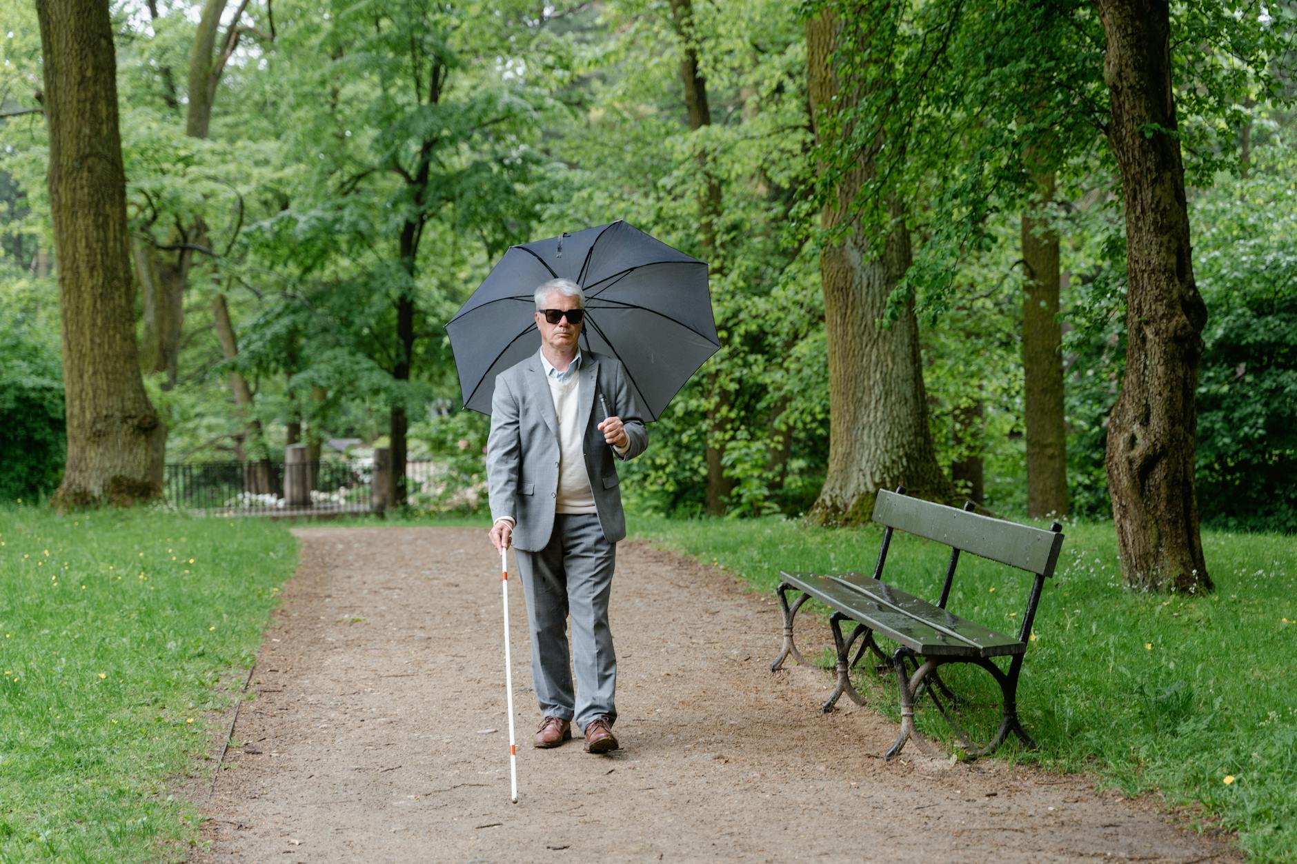 Senior man walking outdoors with a walking stick to stay active and improve leg circulation