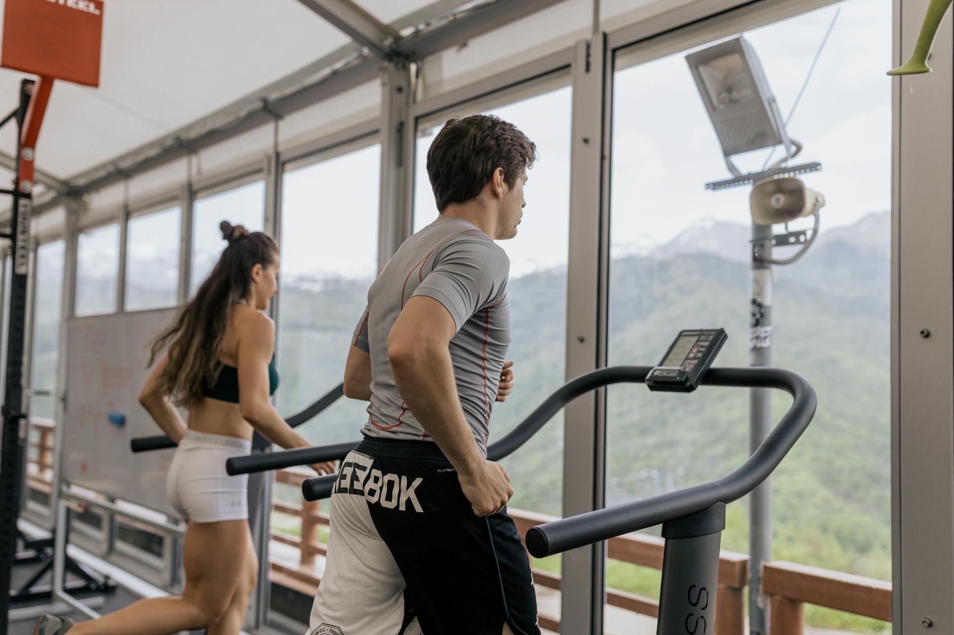 Exercise for Natural Liver Detoxification Two people running on treadmills in a gym — regular exercise supports liver detox naturally