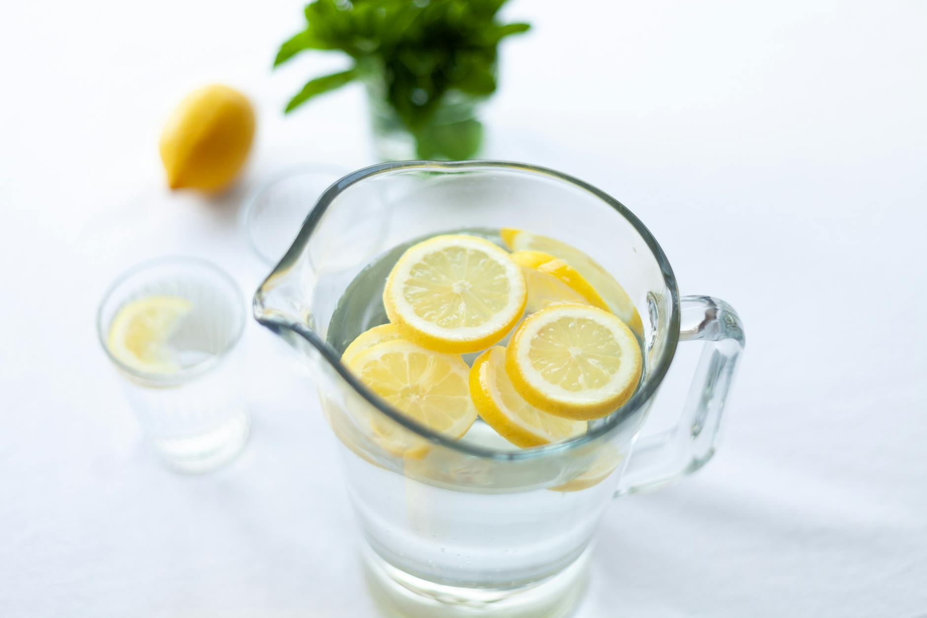 Hydration for Liver Detox Support Lemon slices in a pitcher of water — staying hydrated supports natural liver detox
