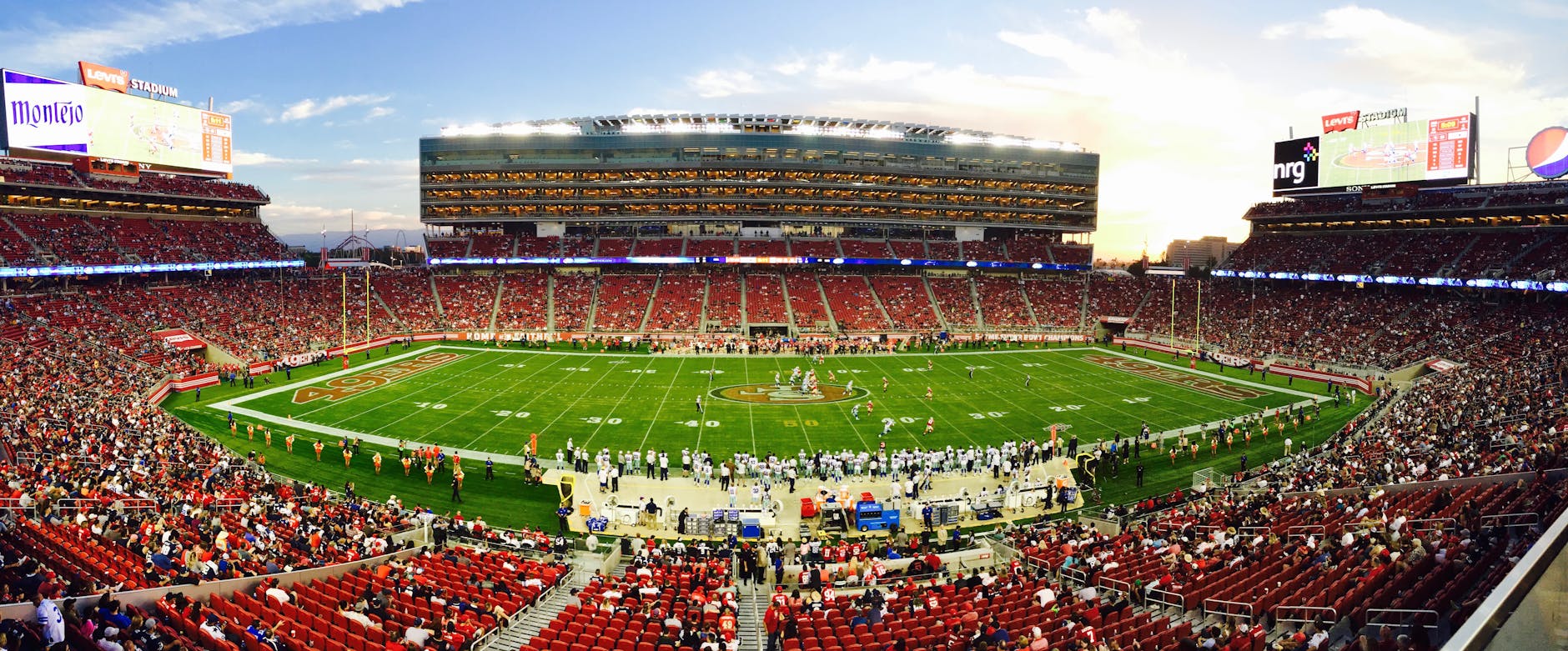 Sports Stadium Packed With Fans at March Madness 2026 Packed stadium with thousands of fans watching a live sporting event at sunset