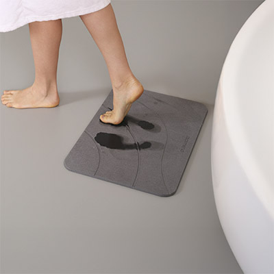 Close-up of MatMend diatomaceous earth bath mat surface showing water absorption treatment