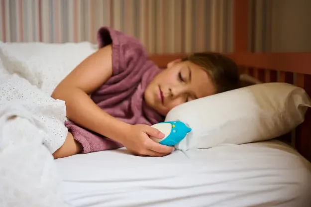 Child holding Moonbuddy breathing device during a calming session