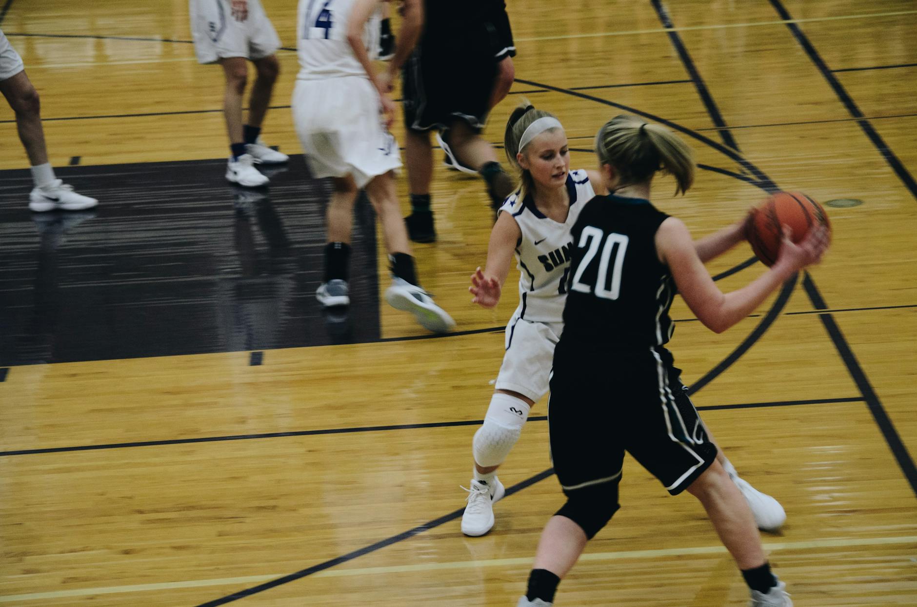 Basketball players competing aggressively on the court during a professional game