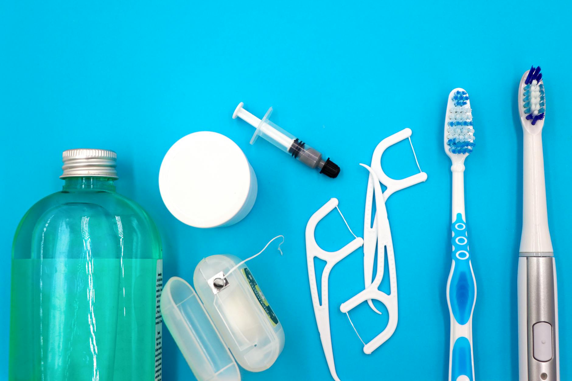 Oral hygiene essentials including toothbrushes, floss, and mouthwash — a complete daily oral care routine is one of the most impactful investments in long-term systemic health
