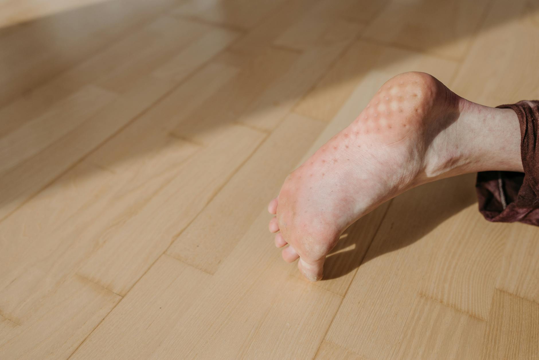 Plantar Fascia Location on the Foot Sole Close-up of the sole of a bare human foot, showing the arch area where the plantar fascia runs