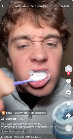 Purely White Deluxe Application 2026 Young man applying Purely White Deluxe whitening powder with a toothbrush
