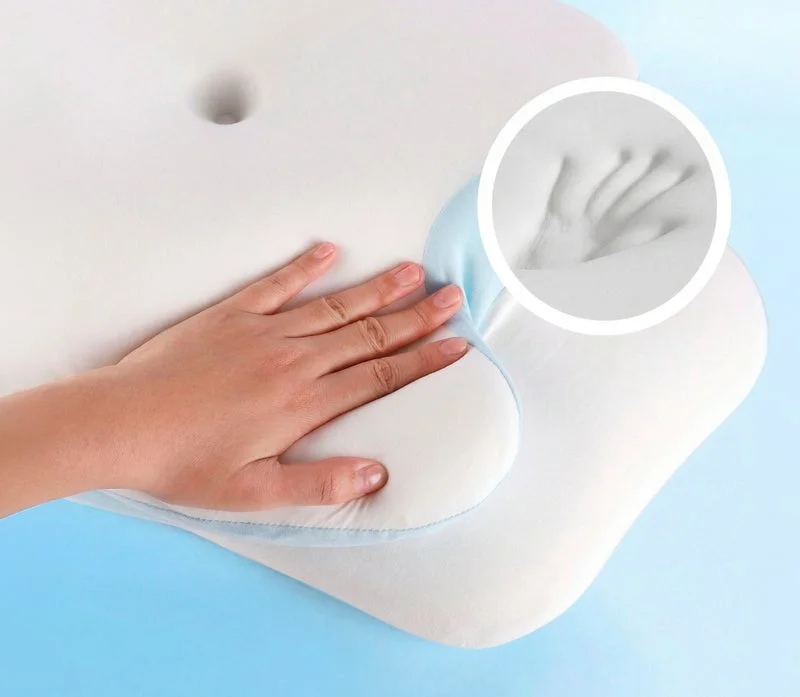 VelaSleep promotional image showing a hand pressing the pillow foam