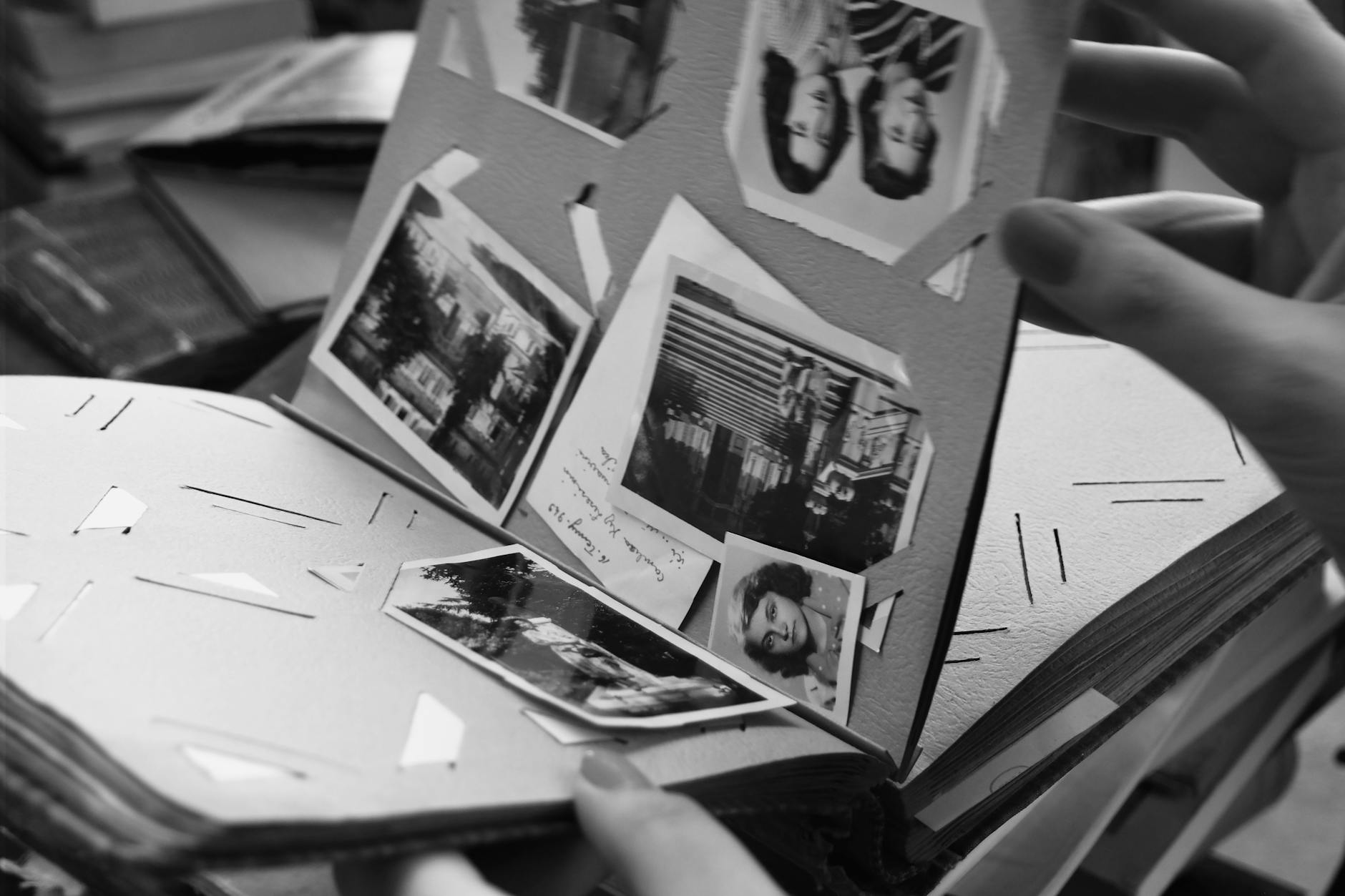 Classic black and white photo album open on a table — printed photo books preserve family memories for generations