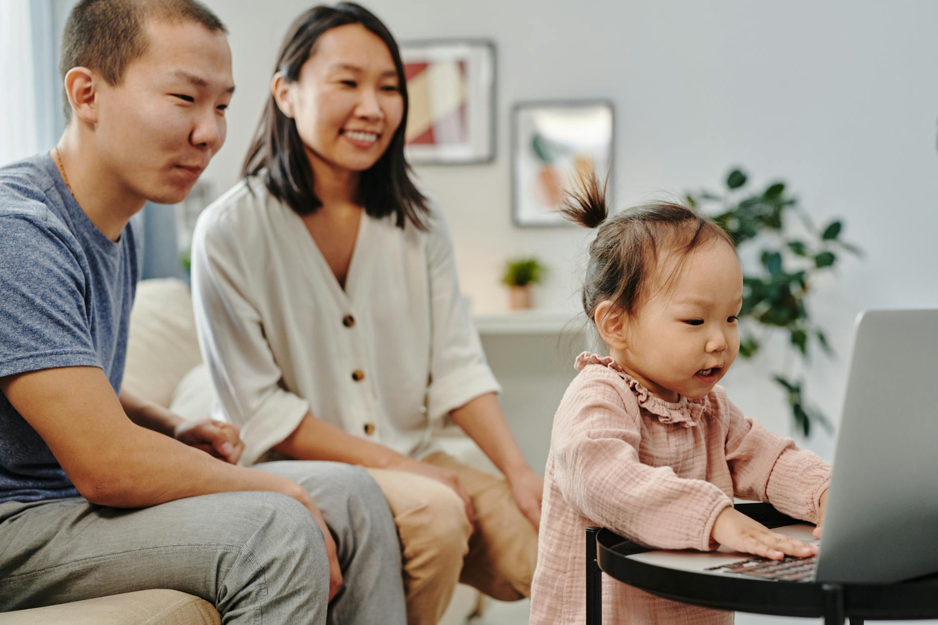 Family gathered around a laptop for a video call — hosting virtual photo viewing parties with relatives