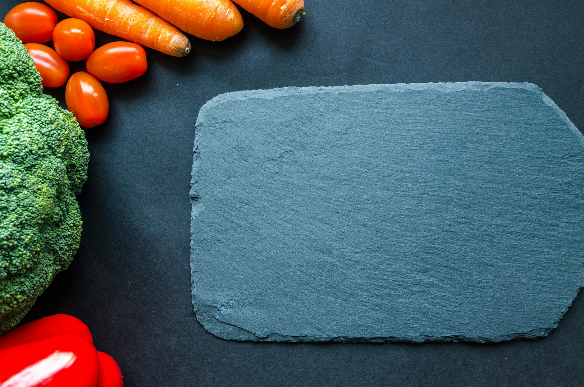 Liver-Supportive Nutrition - Vegetables and Whole Foods for Liver Health Colorful fresh vegetables on a slate board, representing liver-supportive nutrition and a healthy diet