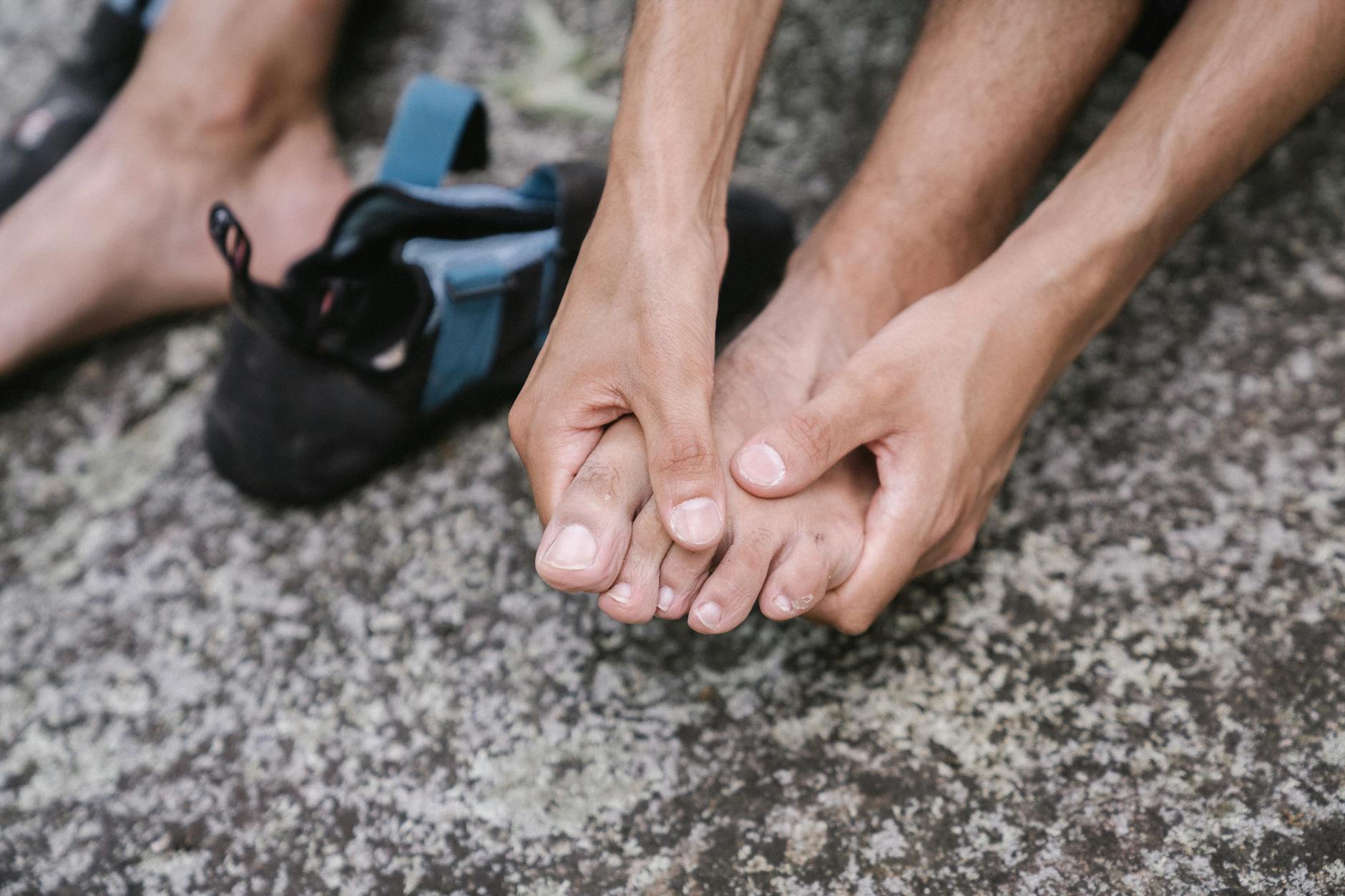 Self-Massage Techniques for Foot Pain Relief After Work Person massaging bare feet outdoors after a long day of work