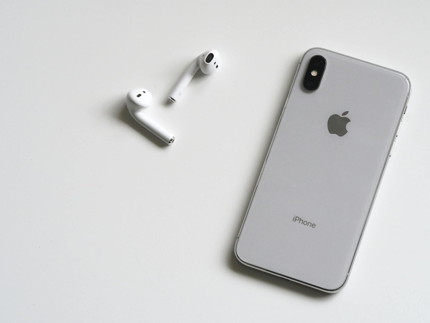 Smartphone and wireless earbuds — core travel tech gadgets for international travel in 2026