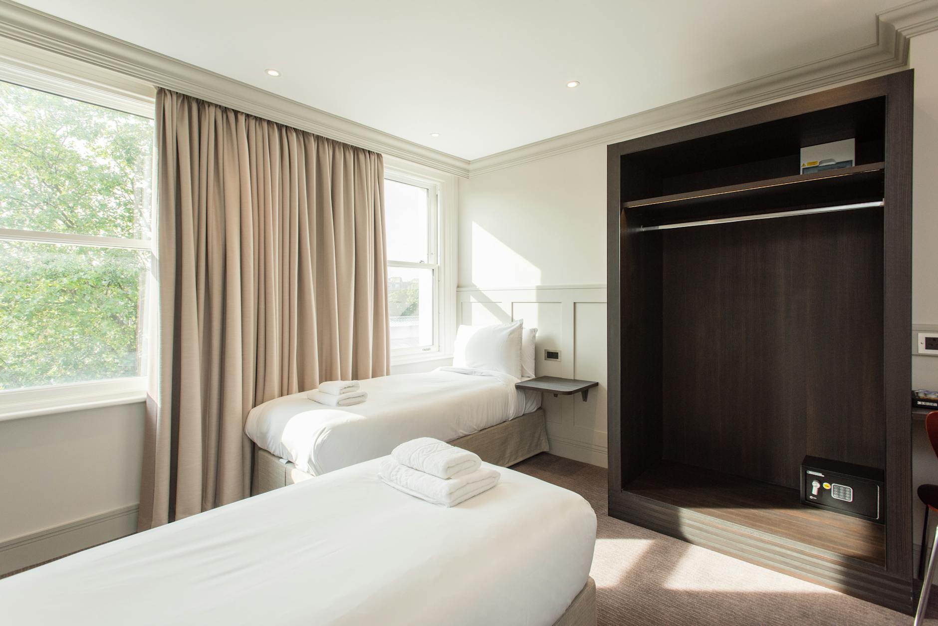 Hotel Room Luggage Security Tips Clean and organized hotel room where travelers should store luggage securely