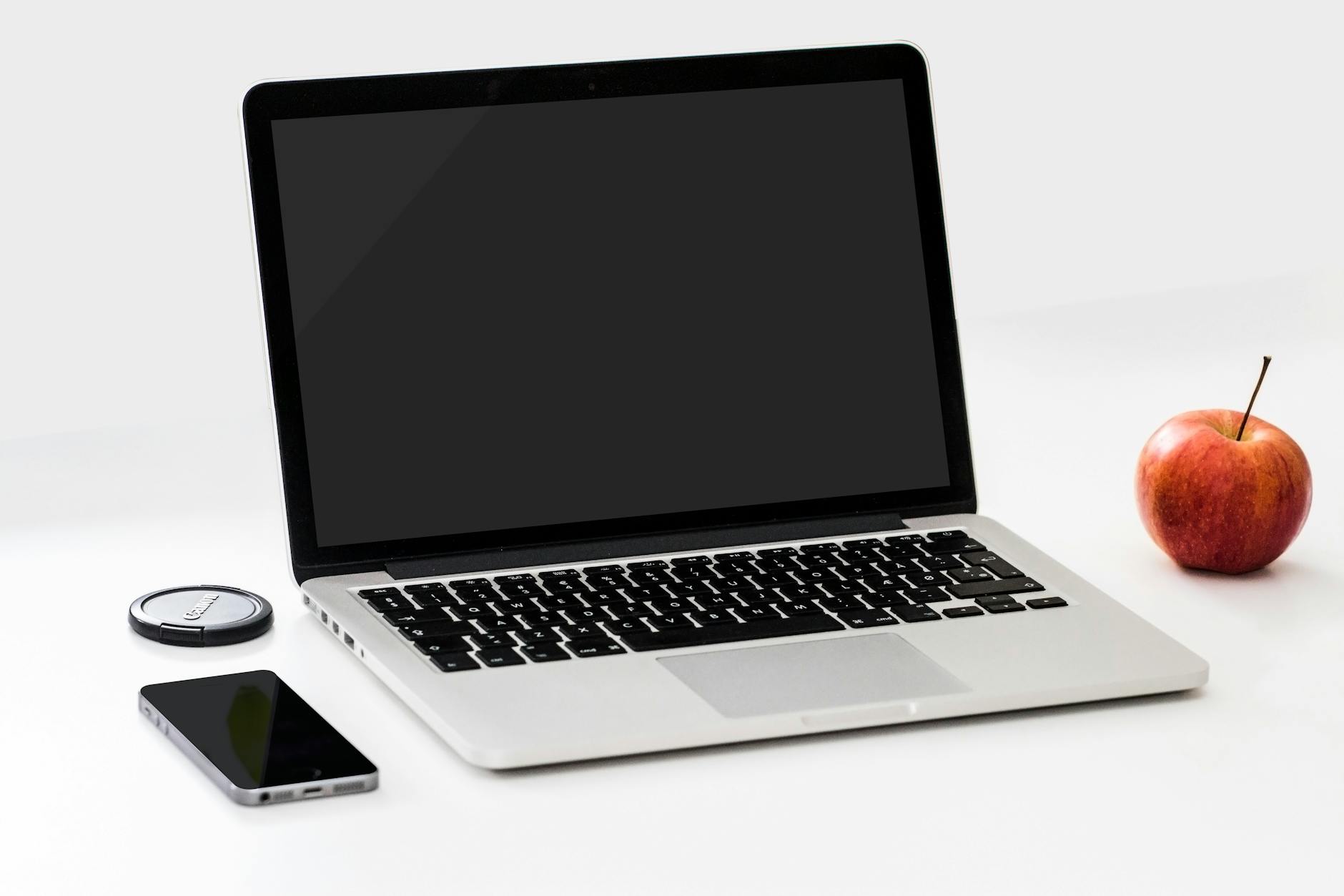 Travel Tech Gadgets 2026 - Laptop and Smartphone Essentials Laptop and smartphone on desk representing essential travel tech gadgets