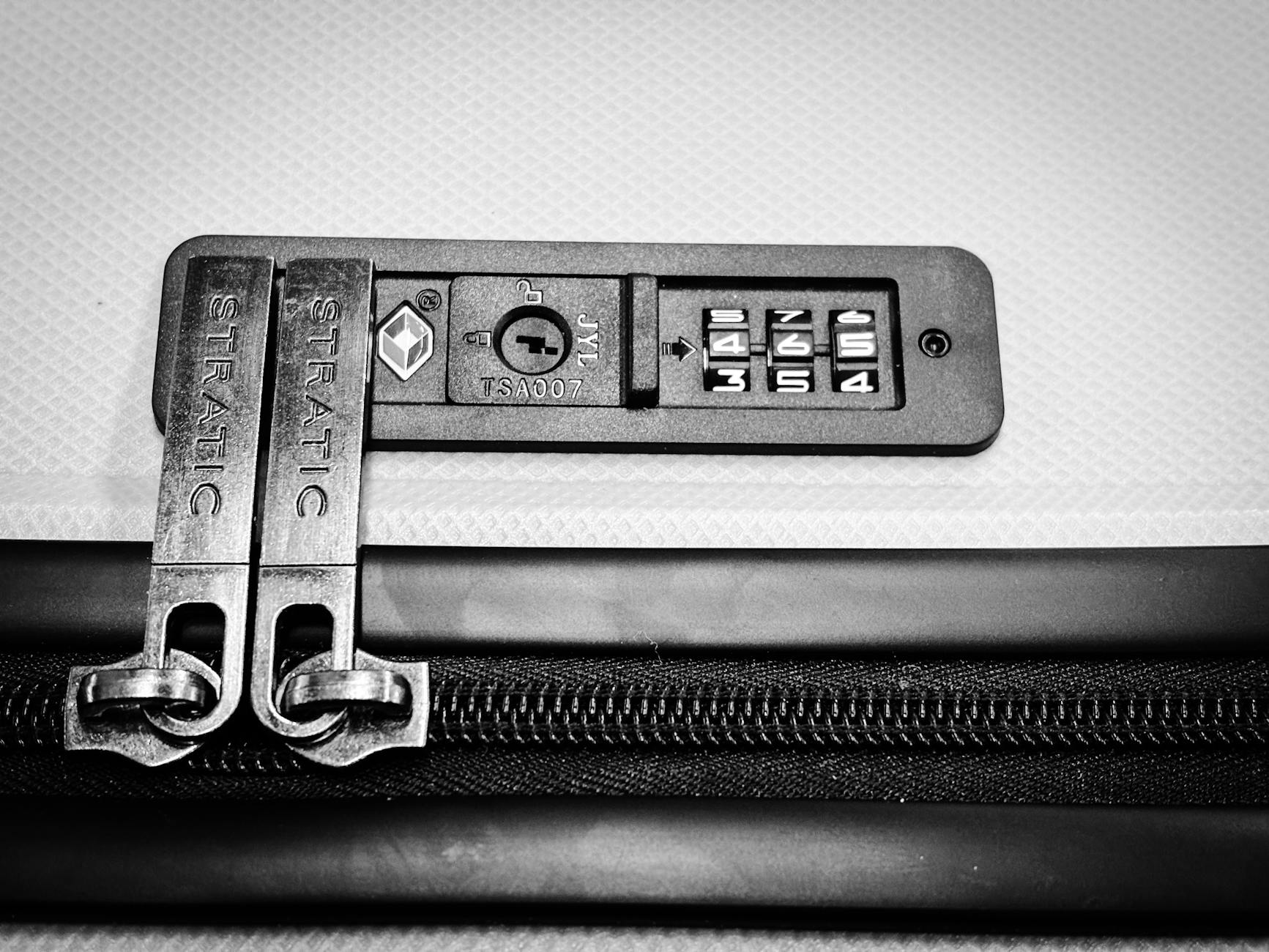 TSA-approved lock on a suitcase representing travel security compliance
