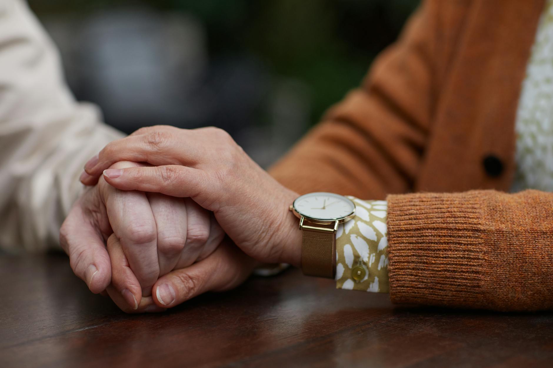 Senior couple holding hands, representing the importance of maintaining close relationships when managing hearing loss