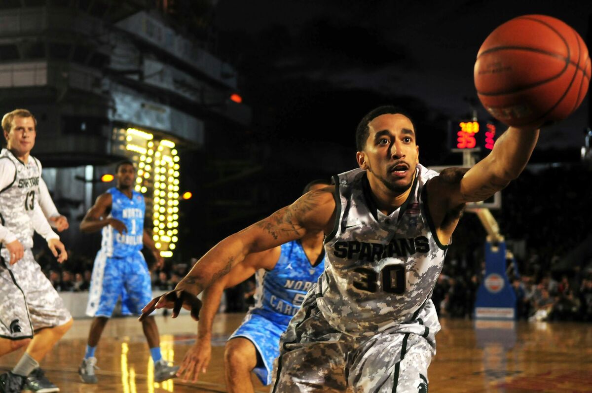 Basketball teams competing in an intense game, representing the competitive spirit of the NCAA tournament
