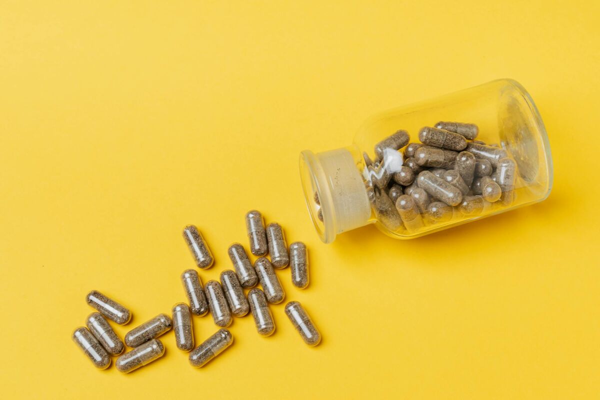 Next-Generation Gut Health Supplement Capsules Supplement capsules spilling from a glass bottle representing next-generation gut health products