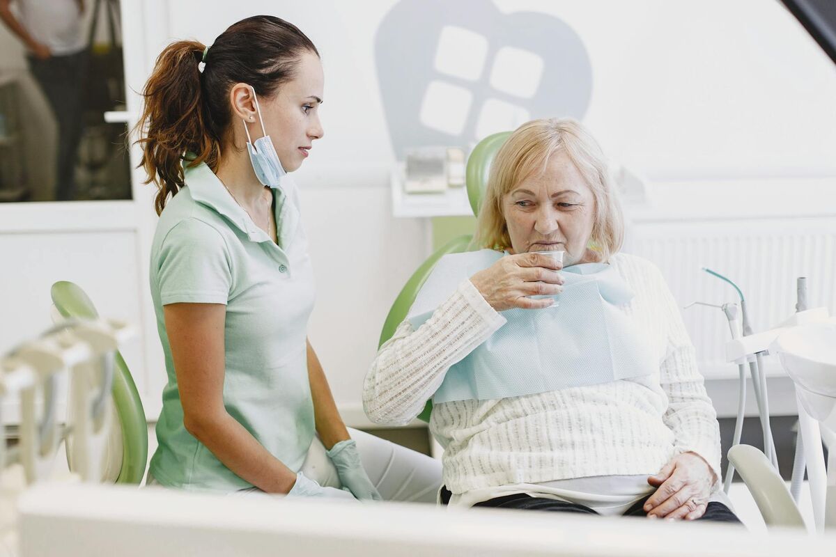 Dentist consulting with a senior female patient in a dental clinic