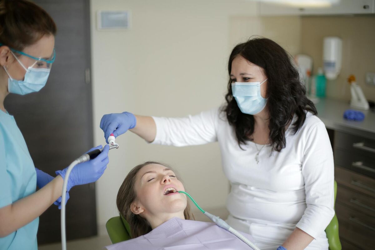 Patient receiving dental treatment in a dentist's chair representing cavity prevention