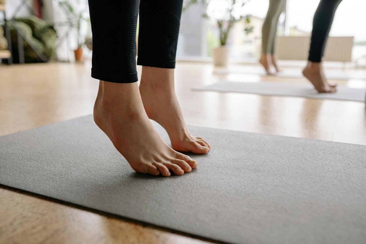 Close-up of bare feet during a yoga session, showing mindful foot placement on a mat