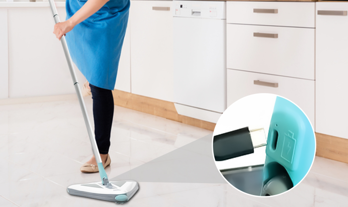 Zippi Sweeper cleaning a floor corner showing the triangular head reaching into the angle